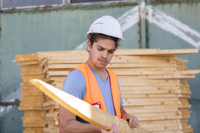 Young construction engineer with helmet working outside