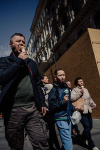 Low angle view of man standing in city