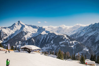 Scenic view of mountains against blue sky