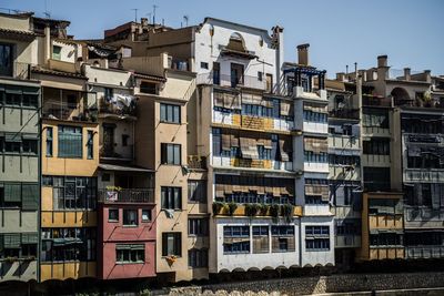 Low angle view of buildings in town against sky