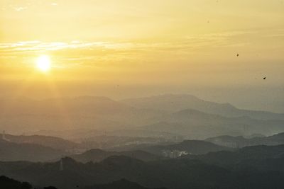 Scenic view of mountains against sky during sunset