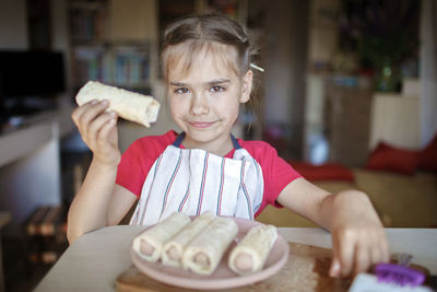 Portrait of smiling girl holding sweet food