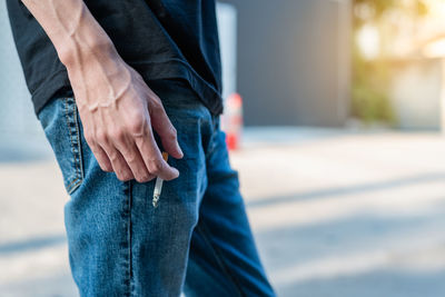 Midsection of man standing in park