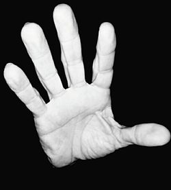 Close-up of human hand against black background