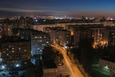 High angle view of illuminated city buildings at night