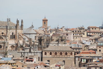 Buildings in city against clear sky