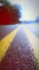 Surface level of road against clear sky