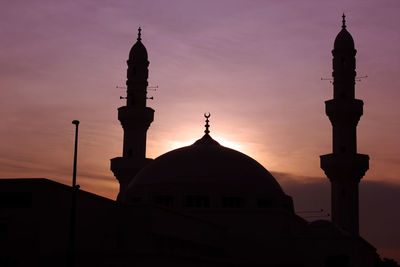 Silhouette of building against sky during sunset