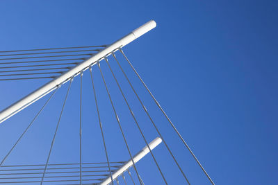 Low angle view of bridge against clear blue sky