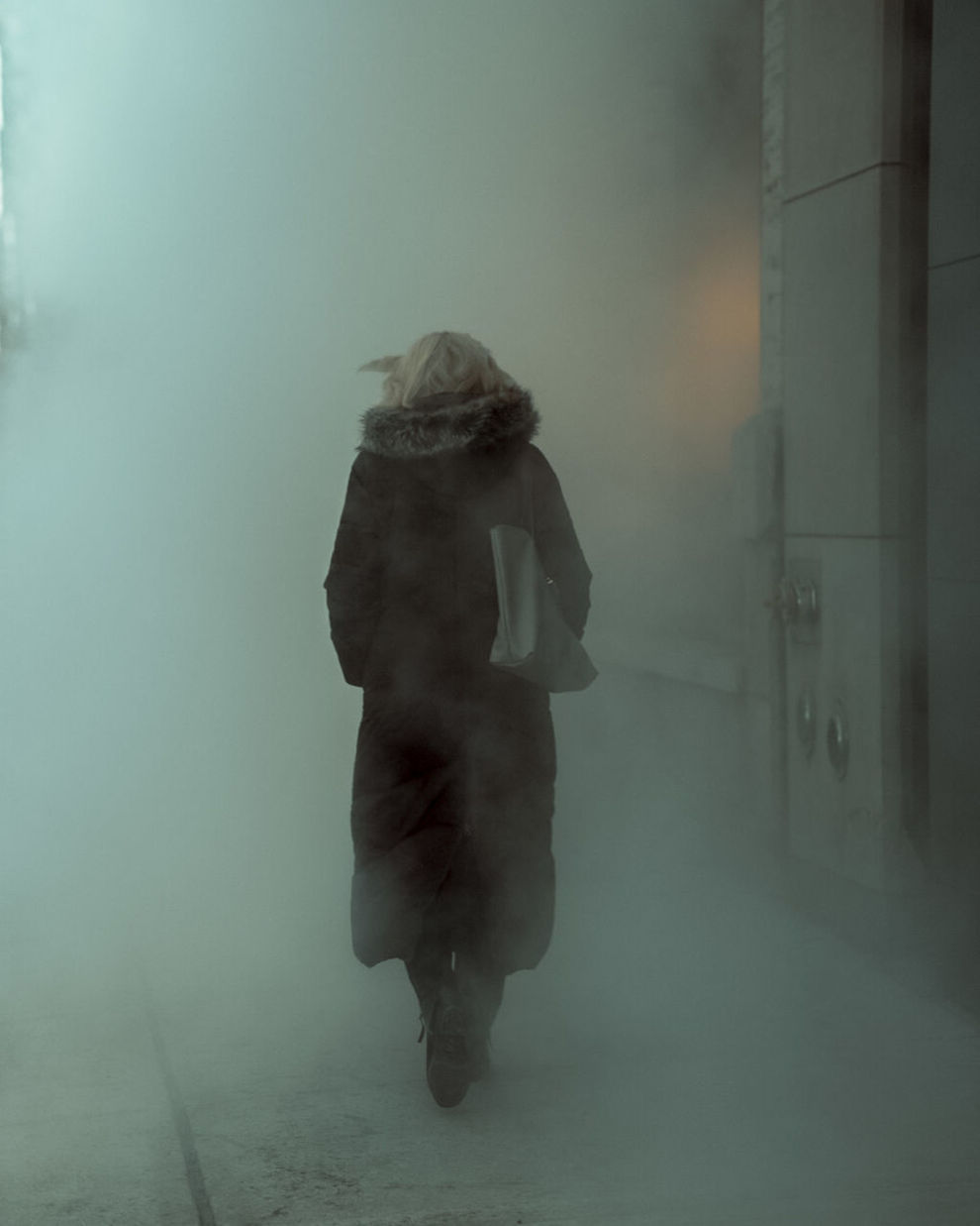 REAR VIEW OF WOMAN WALKING ON FOGGY DAY