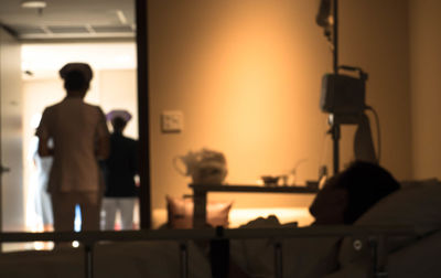 Rear view of man photographing at table
