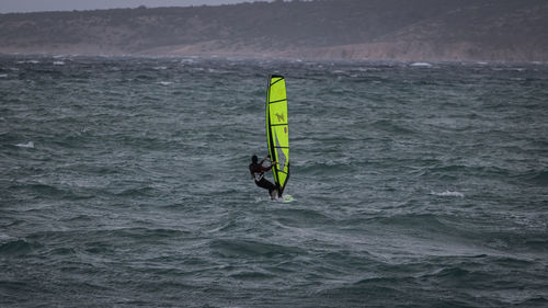 Person paragliding in sea