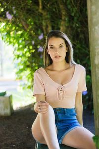 Portrait of a young woman sitting outdoors