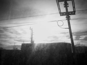 Low angle view of electricity pylon against sky