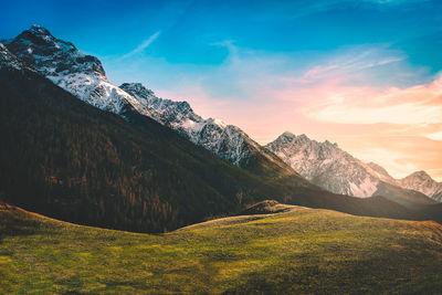 Scenic view of mountains against sky at sunset