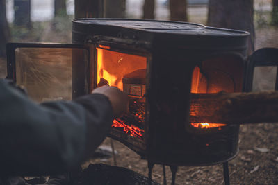 Campsite in winter. smoking food over an open fire in a wood stove outdoors.