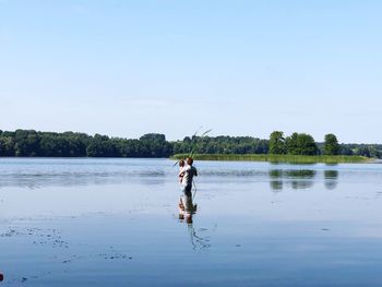 Full length of woman on lake against sky