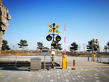 Yellow road sign against clear blue sky