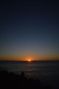 Scenic view of sea and clear sky during sunset
