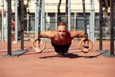 Low angle view of man exercising in gym