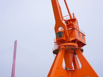 Low angle view of crane against clear sky