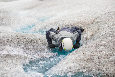 High angle view of man lying down in swimming pool