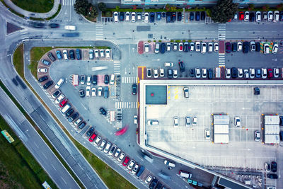 Aerial view from the drone of a supermarket parking lot crowded with cars. 