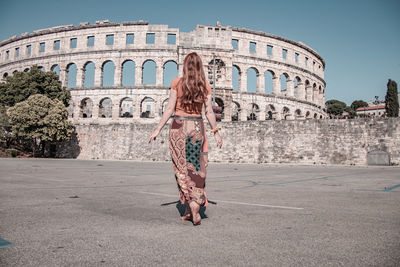 Rear view of woman walking on street