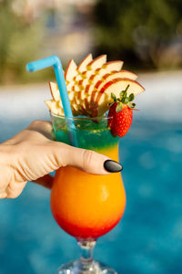 Close-up of hand holding strawberry