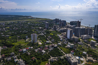 High angle view of buildings by sea against sky