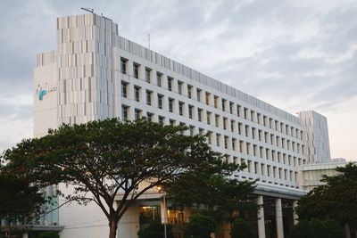 Low angle view of office building against sky