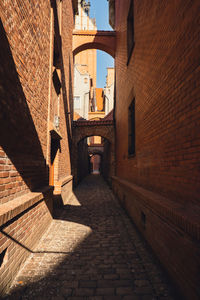 Rear view of man walking in tunnel