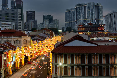 High angle view of decorations hanging on city street at night