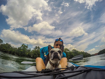 Man in boat against sky