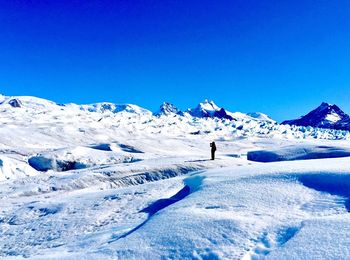 Scenic view of snowcapped mountains against clear blue sky