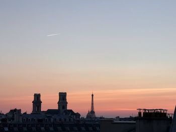 Mid distance view of eiffel tower against sky during sunset
