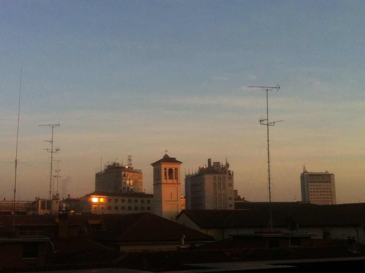 building exterior, architecture, built structure, sunset, city, sky, residential structure, residential building, building, house, dusk, residential district, silhouette, outdoors, no people, tower, power line, street light, crane - construction machinery, cityscape