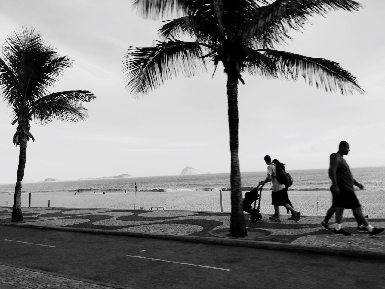 sea, real people, full length, lifestyles, sky, water, tree, men, outdoors, beach, day, nature, two people, beauty in nature, rear view, scenics, horizon over water, leisure activity, palm tree, togetherness, women