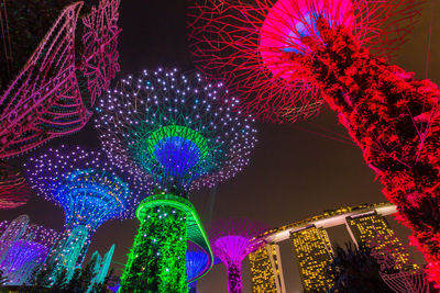 Low angle view of illuminated ferris wheel at night