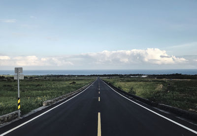 Empty road along countryside landscape