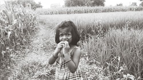 Portrait of girl standing on field