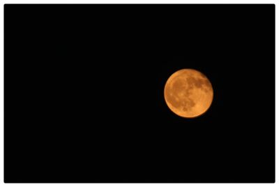 Low angle view of moon against clear sky at night