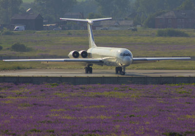 Airplane flying over field during rainy season