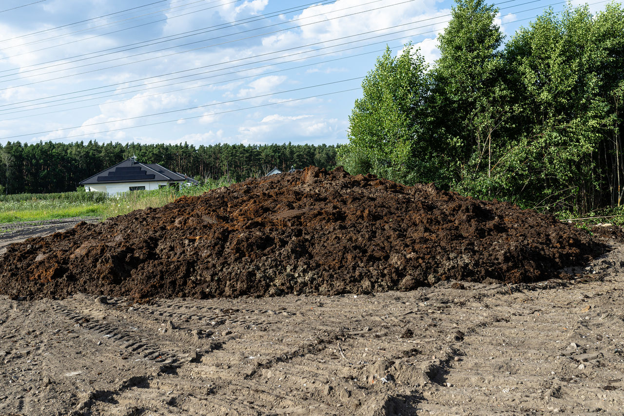 soil, plant, field, sky, nature, tree, land, day, growth, cloud, no people, landscape, dirt, agriculture, environment, industry, outdoors, construction industry, heap, sunlight, asphalt