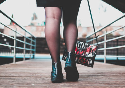 Low section of woman standing on ground