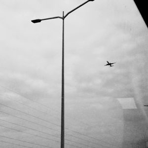 Low angle view of airplane flying in sky