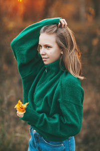 Portrait of a beautiful teenage girl with blond hair and blue eyes with a smile on her face