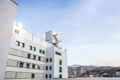 Low angle view of buildings in town against sky