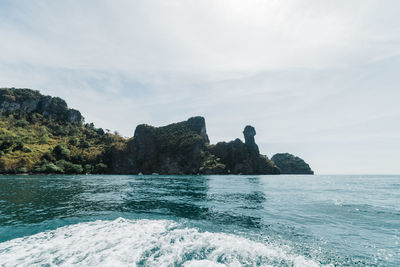 Scenic view of rocks in sea against sky