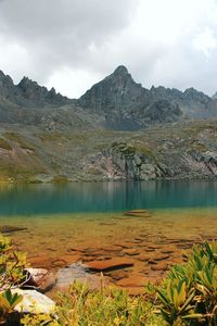 Scenic view of lake and mountains against sky